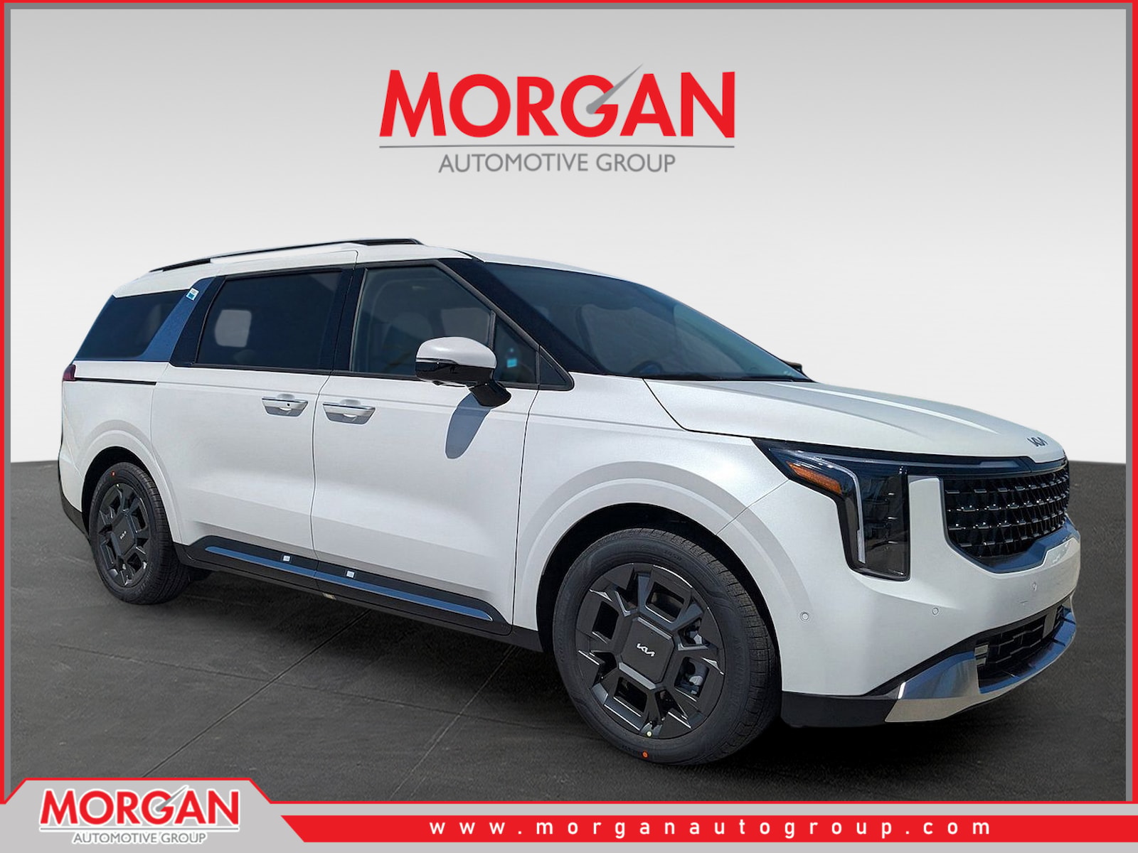 2026 Kia Carnival SX in Snow White Pearl — front three-quarter view